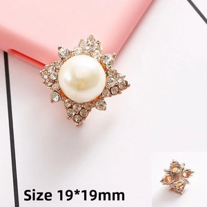 Detail of square 19x19mm gold flower charm with center pearl and sparkling rhinestones