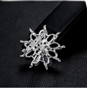 Close-up of a silver alloy star brooch featuring intricate hollowed-out floral details