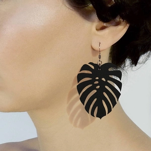 Minimalist black monstera leaf drop earring worn by model for a chic Nordic style