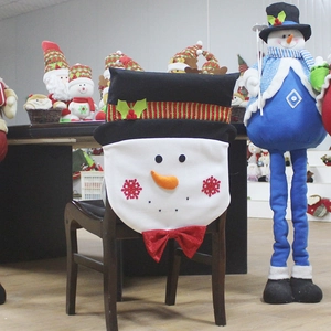 Christmas snowman chair covers and matching festive ornaments for holiday dining room decor