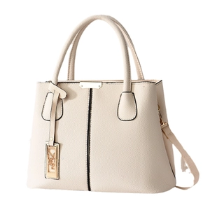 Elegant cream leather tote bag for women featuring golden hardware and top handles