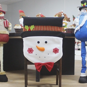Christmas snowman chair cover with red bow and carrot nose for holiday dining decor