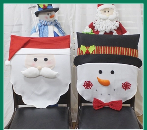 Detailed view of Santa and Snowman chair covers on wooden chairs for Christmas decor