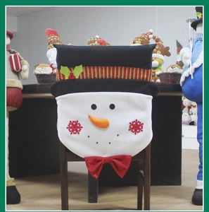 Detail of Christmas snowman chair cover with 3D carrot nose and red sequin bow decoration
