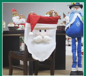 Detail of Santa Claus chair cover with 3D beard design for festive dining room decor