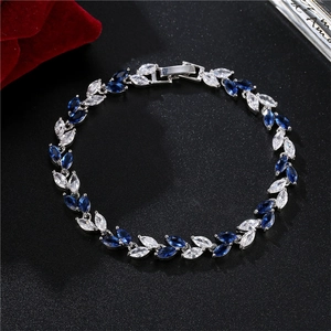 Close-up of elegant marquise-cut blue and white zircon stones on a silver bracelet