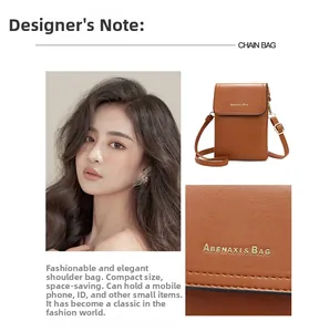 Detail of brown litchi pattern leather crossbody phone bag with brand logo and strap