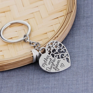 Silver heart-shaped keychain with Mother and Daughter Forever engraving on bamboo decor
