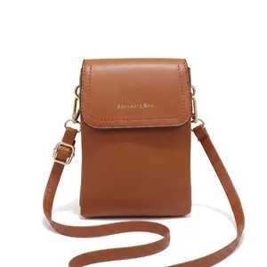 Detailed close-up of brown PU leather crossbody bag with ABENAXI logo and shoulder strap