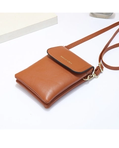 Detail of brown leather crossbody bag featuring gold lettering and metallic D-ring hooks