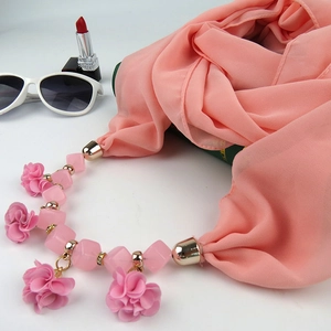 Close-up of pink floral chiffon scarf necklace with small flowers and gold metal clasp