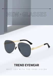 Close-up of golden stainless steel double bridge and dark grey lenses on aviator sunglasses