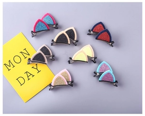 Close-up of glitter cat ear hair clips for girls in various colorful sequin patterns