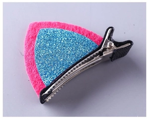 Detail shot of a pink felt cat ear hair clip with blue glitter and metal duckbill clip