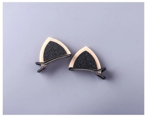 Detailed view of sequin cat ear hair clips with beige faux fur and black glitter