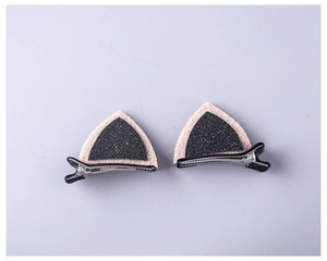 Detail view of glitter cat ear hair clips with non-woven fabric on black duckbill clips