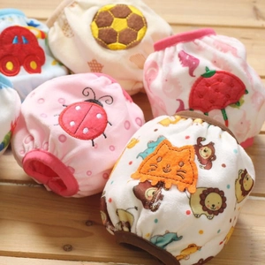 Stack of colorful cotton baby training pants with cute embroidered animal patterns