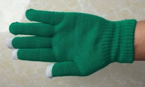 Detailed view of green knitted gloves with grey touchscreen tips for cold weather protection