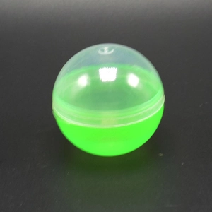 Detail of 45-50mm bright green and transparent spherical plastic capsule toy shell