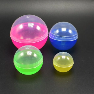 Set of four colorful transparent plastic capsule shells in various sizes on black background