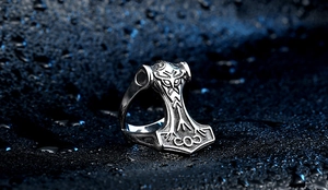 Detail of Viking Mjolnir ring featuring intricate Nordic runes and a vintage silver finish