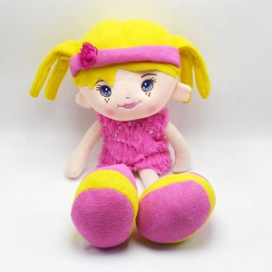 Cute plush girl doll with yellow braids and pink sequin dress on white background