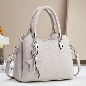 Elegant beige bucket bag with lychee texture, star charm and adjustable shoulder strap