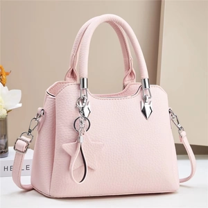 Detail shot of pink bucket bag with lychee grain texture and star pendant charm