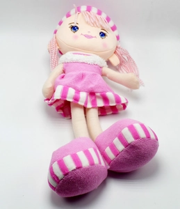 Close-up of pink pastoral rag doll with embroidered facial details and striped hat