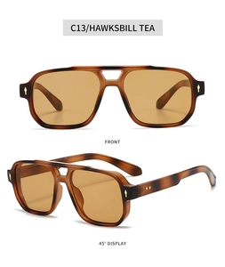 Detail view of double bridge navigator sunglasses in hawksbill tea with metal rivets