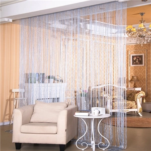 Silver-grey string curtain dividing living room space with flat metallic thread detail