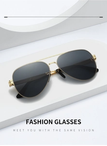 Detail view of gold metal double bridge aviator sunglasses with dark grey lenses