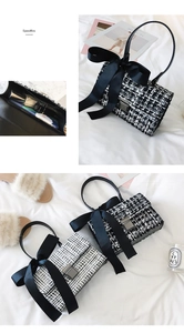 Detail of tweed handbag interior showing space for phone and lipstick with metal lock
