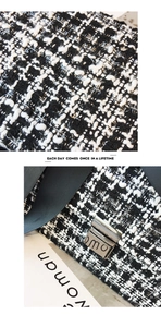 Close-up of black and white tweed fabric texture with silver metal clasp on the handbag