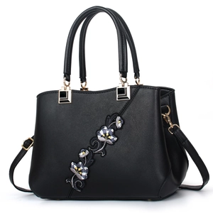 Elegant black leather handbag for women featuring floral embroidery and gold hardware