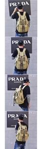 Detail view of khaki canvas backpack with leather buckle straps and side pockets on model