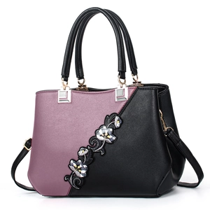 Women's burgundy and black leather crossbody bag with floral embroidery and gold hardware