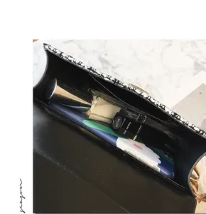 Detail showing internal capacity of the tweed square bag with phone and cosmetics