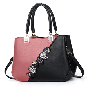 Elegant women's crossbody handbag with floral embroidery and contrast color design