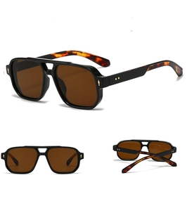 Detail view of square pilot sunglasses with tortoiseshell temples and metal arrow rivets