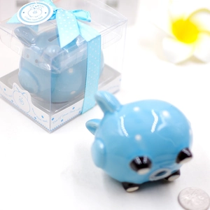 Detailed view of blue polka dot ceramic piggy bank in gift box with ribbon