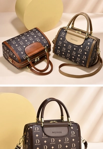 Detailed close-up of brown and beige monogram boston handbag with dual zipper closure