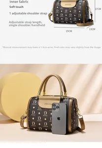 Detailed view of brown monogram Boston bag with adjustable strap and 25cm base size