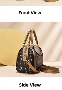 Detail of vintage pattern Boston bag with gold metal handles and wide strap