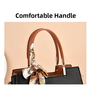Detail of black crocodile pattern leather handbag with silk scarf on the round handle