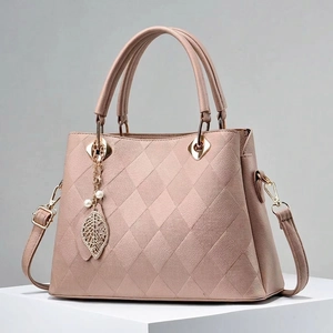 Mauve quilted leather tote bag with leaf pearl charm and adjustable shoulder strap