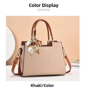 Close-up of khaki women handbag featuring crocodile texture and elegant silk scarf detail
