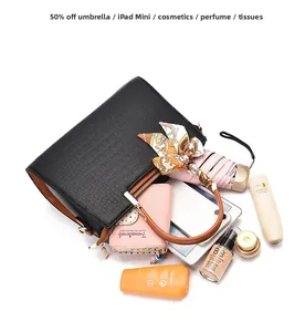 Top view of black crocodile pattern handbag showing spacious interior and daily essentials