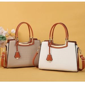 Detail view of stylish crocodile pattern handbags with gold metal bars and shoulder straps