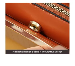 Detail of orange lychee grain leather handbag featuring gold magnetic snap closure